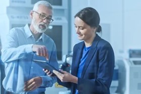 Engineers collaborating on a tablet