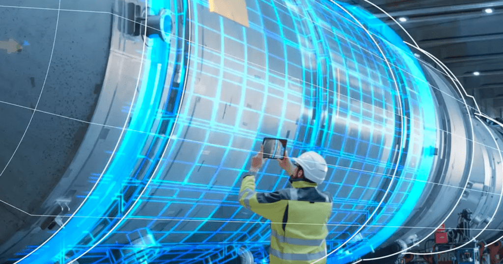 A worker wearing safety gear uses a tablet to inspect a large cylindrical industrial machine, overlaid with a blue augmented-reality wireframe.